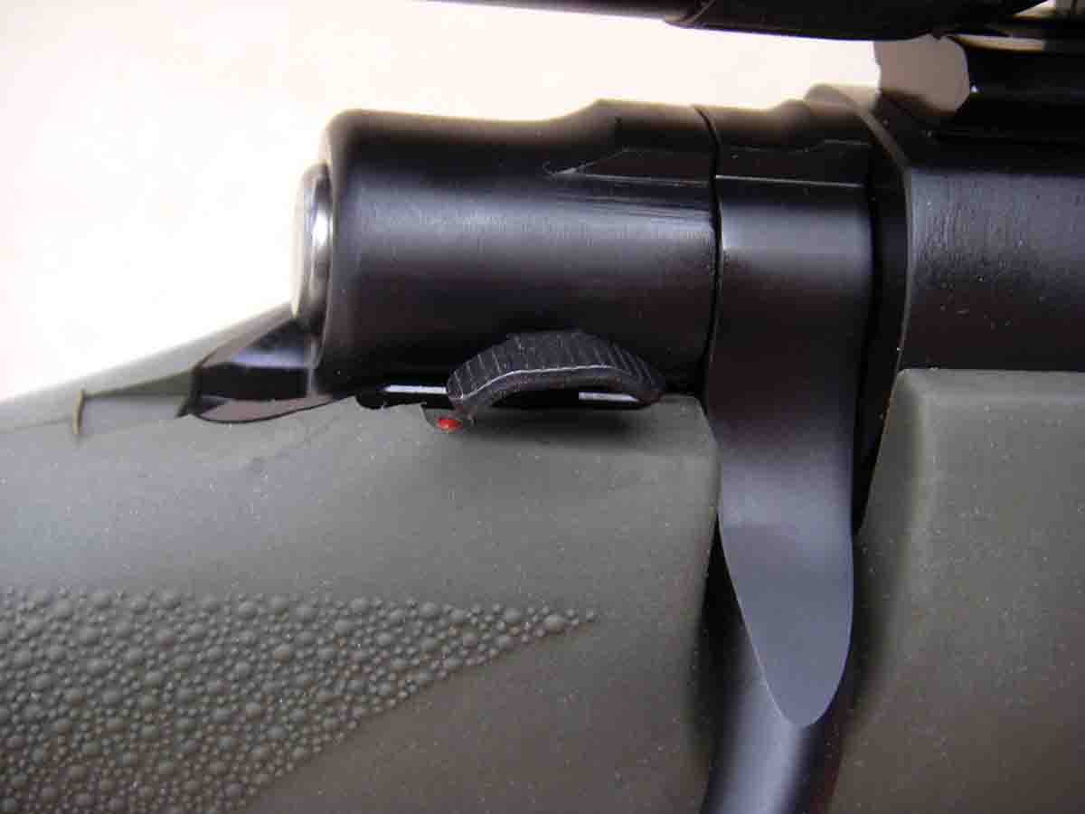 In the rear position, the safety locks the bolt and prevents firing; the middle position prevents firing but allows the bolt to be lifted to remove a cartridge from the chamber; the forward position is “fire.”